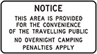 white sign with black text, Notice, this area is provided for the convenience of the travelling public. No overnight camping. Penalties apply