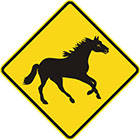 yellow diamond-shaped sign with black galloping horse icon