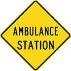 yellow diamond-shaped sign with black text, ambulance station
