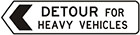 white sign with black arrow and text, detour for heavy vehicles