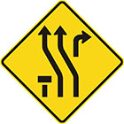yellow diamond-shaped sign with 2 black arrows merging slightly left, another arrow turning right toward the top-right and a T-shape toward the bottom-left