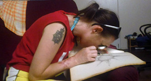 Shelley drawing using a magnifying glass.