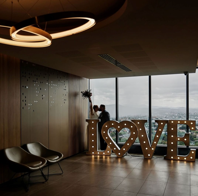 2019 Couple using the LOVE LED photo backdrop