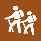 brown sign with icon of 2 people hiking
