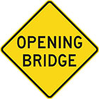 yellow diamond-shaped sign with black text, opening bridge