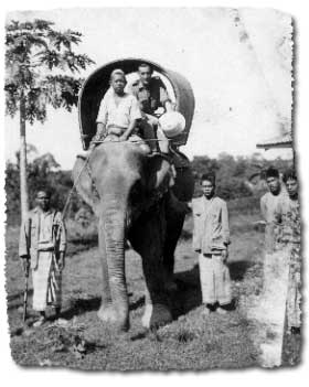 Surveyor EV Corlass travelling by elephant in Malaya, 1921.