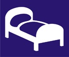 blue sign with white icon of a bed
