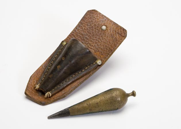 Carrot shaped plumb bob with leather case for storage and transportation