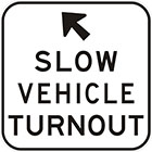 white sign with black arrow and text, slow vehicle turnout