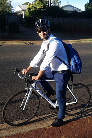 A person commuting to work on a bicycle.