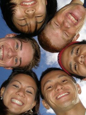 Group of young people smiling at the camera.