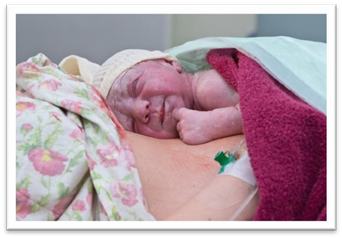 Newborn baby receiving skin to skin contact on their mother’s chest and abdomen following birth.