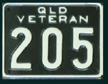 Black background white lettering and numbers on a rectangular vehicle registration plate