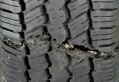 An unsuitable tyre with unsafe damage across the width of the tyre