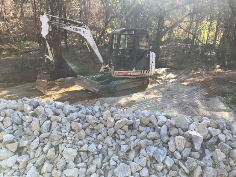 Limestone rock is placed at the toe of the tailing storage facility to help passive treatment of seepage water.
