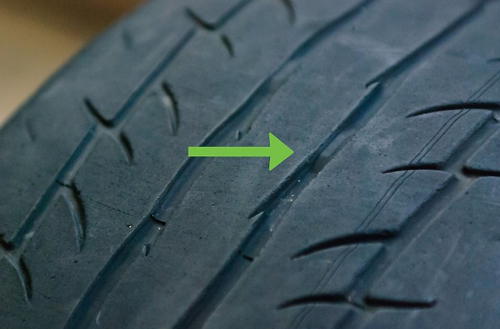 A tyre showing some wear but with indicators below the tyre surface