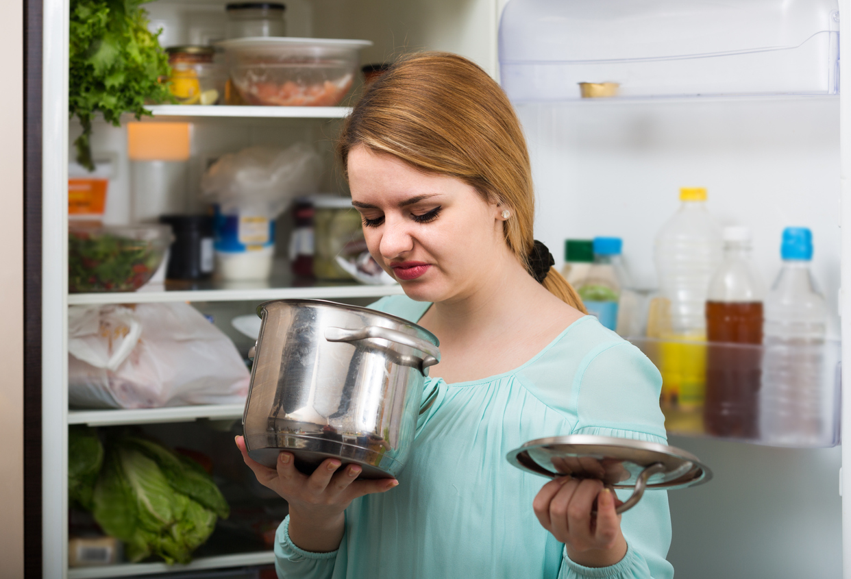 Woman looks unhappily at food
