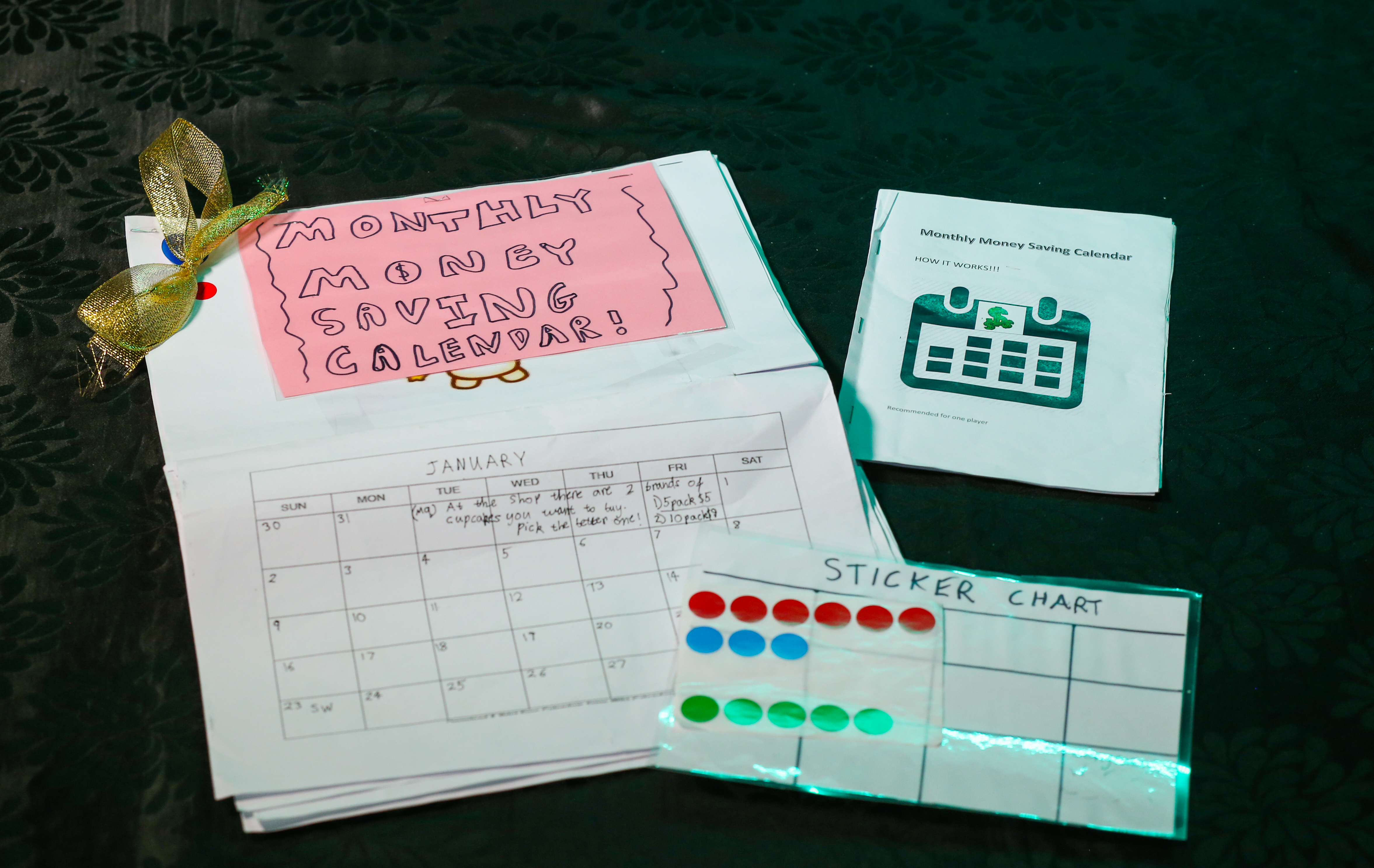 A handwritten calendar, sticker chart and stickers.