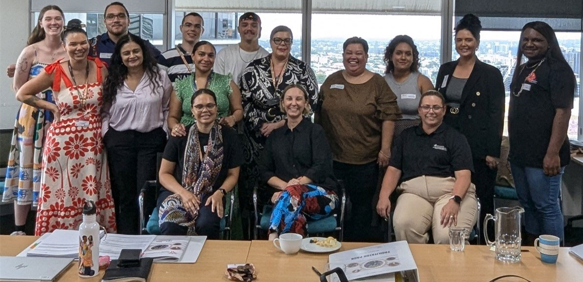 15 people standing for a group photo