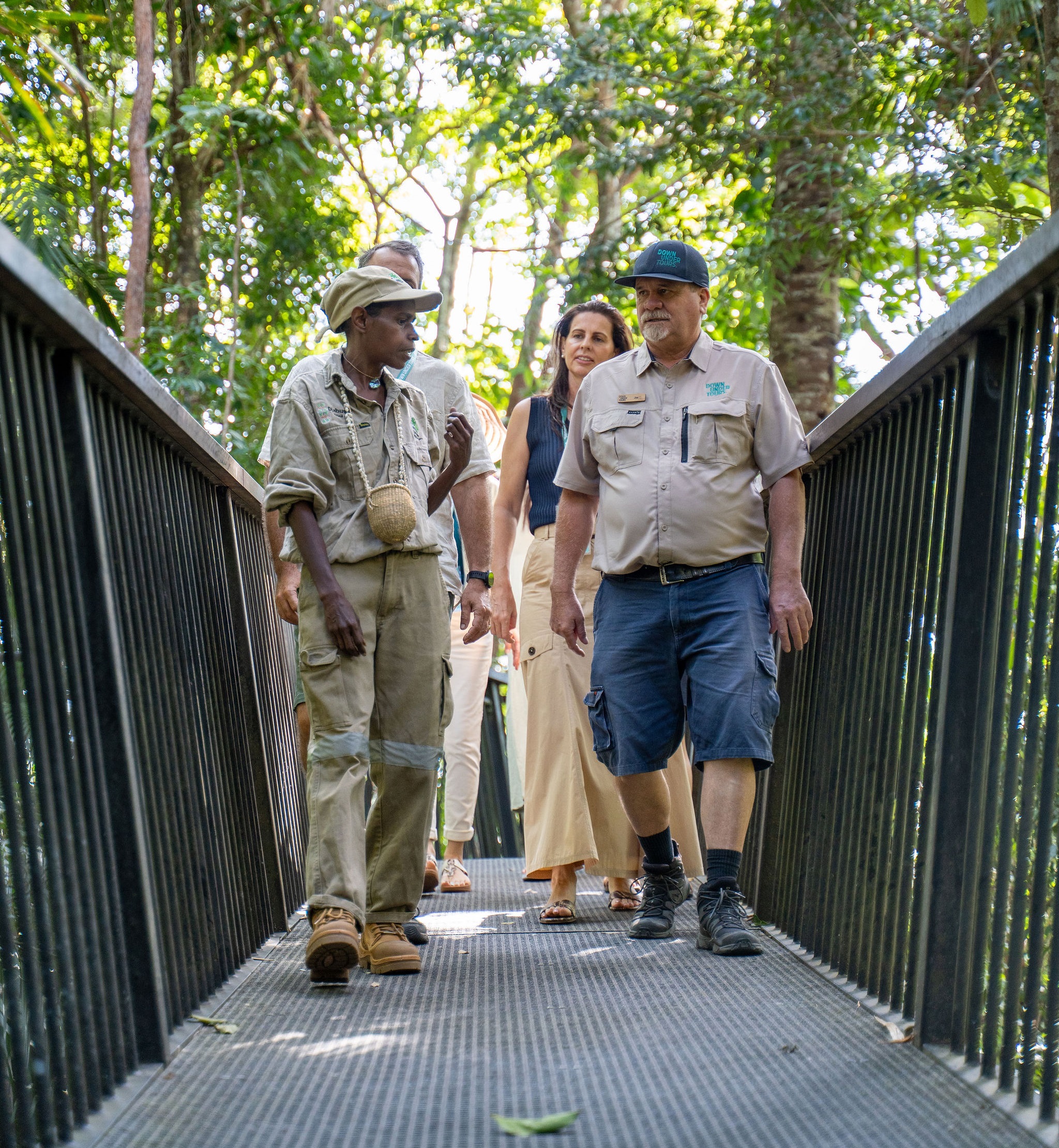 Resized photo of an Indigenous ranger leading a group of tourists on rainforest boardwalk